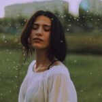 Woman in White Shirt With Green Background