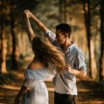 man and woman dancing at center of trees