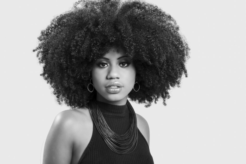 portrait young black woman with great afro hair looking camera