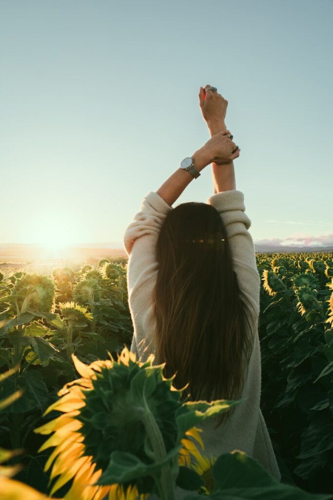 woman surrounded by sunflowers