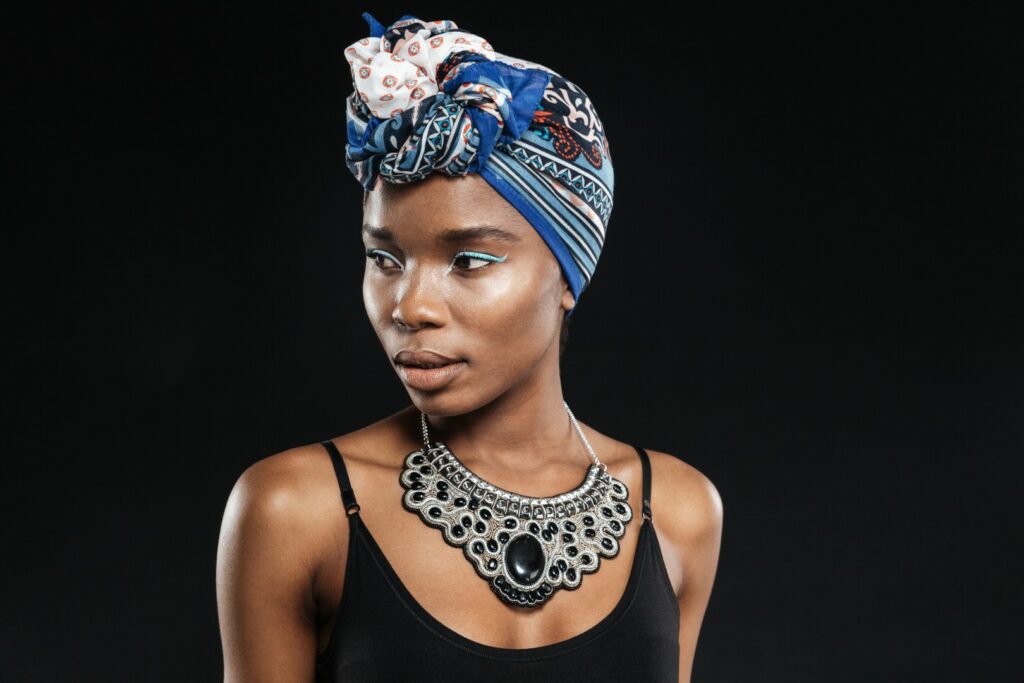 stunning beautiful young stylish black woman isolated black wall